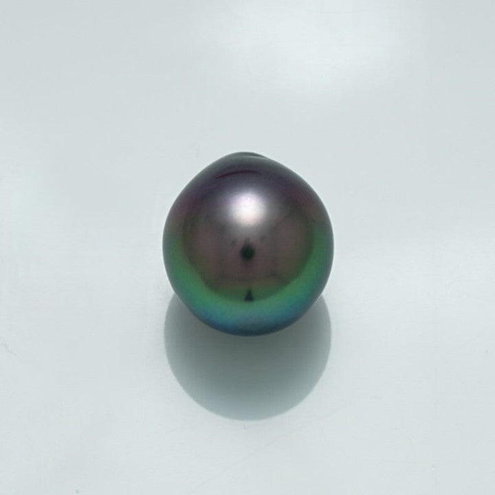 13.5 x 12.2 mm Fijian Drop Pearl with a dark, lustrous surface displaying subtle green and purple overtones, highlighting its unique cultured pearl qualities.