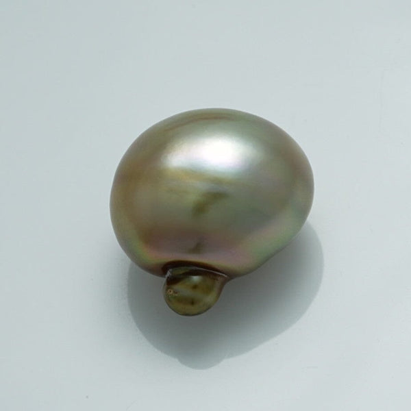 Close-up of a lustrous 18.1 x 14.1 x 18.8 mm Fijian Baroque Pearl showcasing its unique shape and soft iridescent hues of green, brown, and silver.