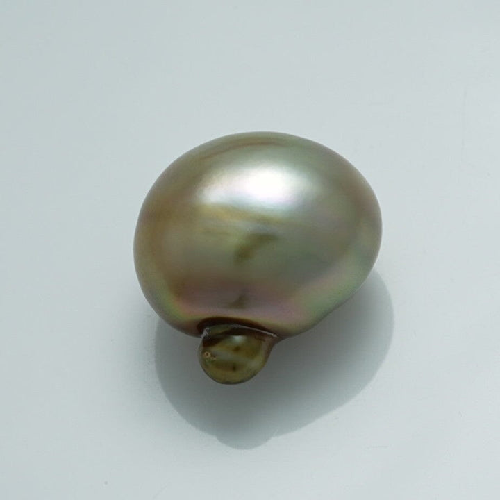 Close-up of a lustrous 18.1 x 14.1 x 18.8 mm Fijian Baroque Pearl showcasing its unique shape and soft iridescent hues of green, brown, and silver.