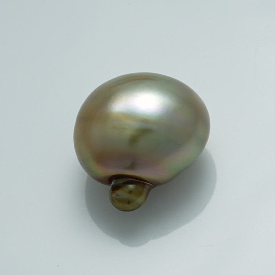 Close-up of a lustrous 18.1 x 14.1 x 18.8 mm Fijian Baroque Pearl showcasing its unique shape and soft iridescent hues of green, brown, and silver.