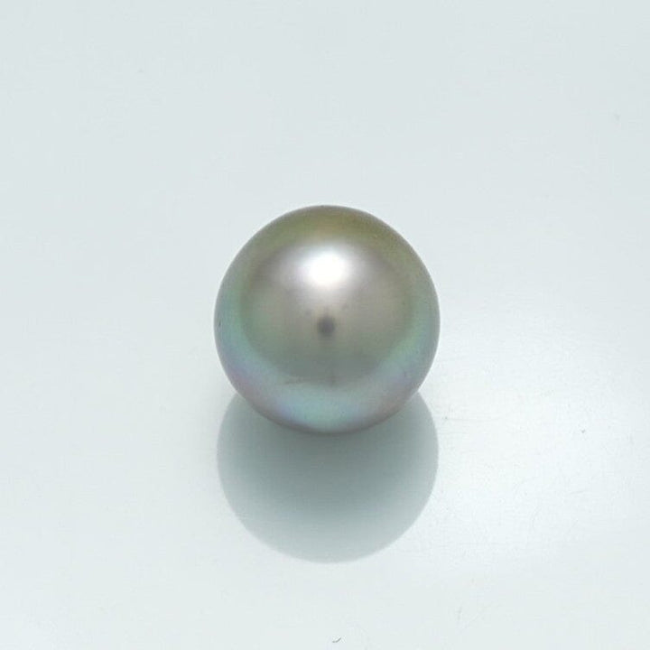 Single lustrous 10.2 x 10.0 mm Fijian Drop Pearl with a smooth surface and subtle iridescent tones on a light background.
