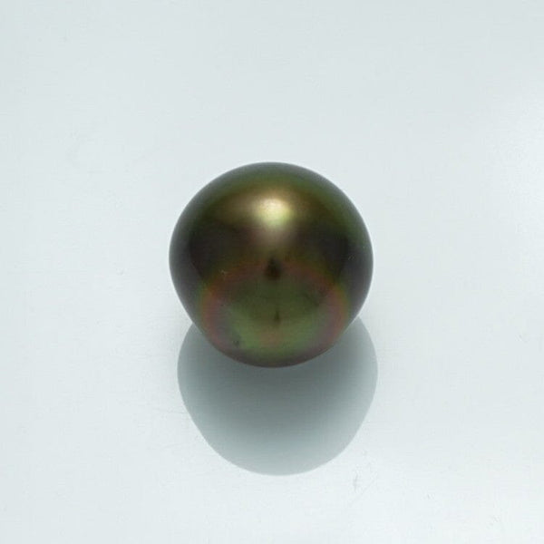 10.8 x 10.6 mm Fijian Baroque Pearl showcasing a dark, iridescent surface with subtle green and bronze hues, reflecting light on a clean white background.