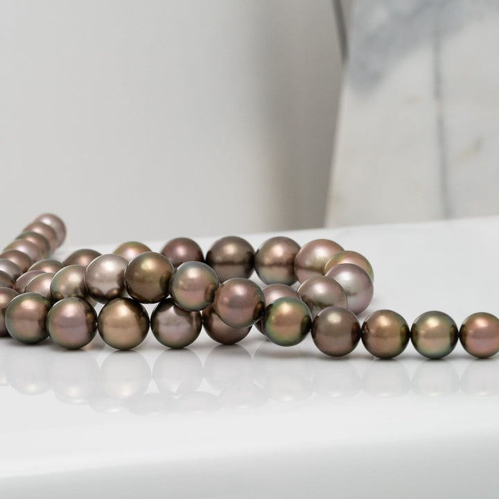9.2–12.5 mm natural-color Dark Chocolate Fijian pearl strand laid out