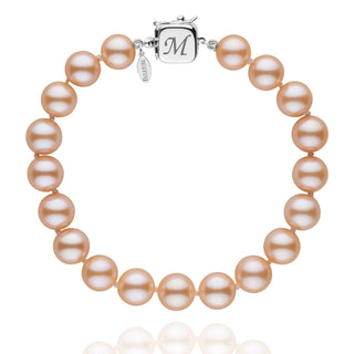 Personalized 8.5-9.0 mm Pink to Peach Freshadama Freshwater Pearl Square Clasp Bracelet with lustrous pink to peach freshwater pearls and a 14K white gold square clasp engraved with the letter M.