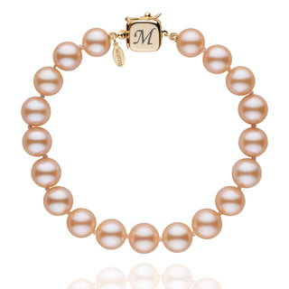 Personalized 8.5-9.0 mm Pink to Peach Freshadama Freshwater Pearl Square Clasp Bracelet featuring lustrous round pearls and a gold square clasp engraved with a custom initial.