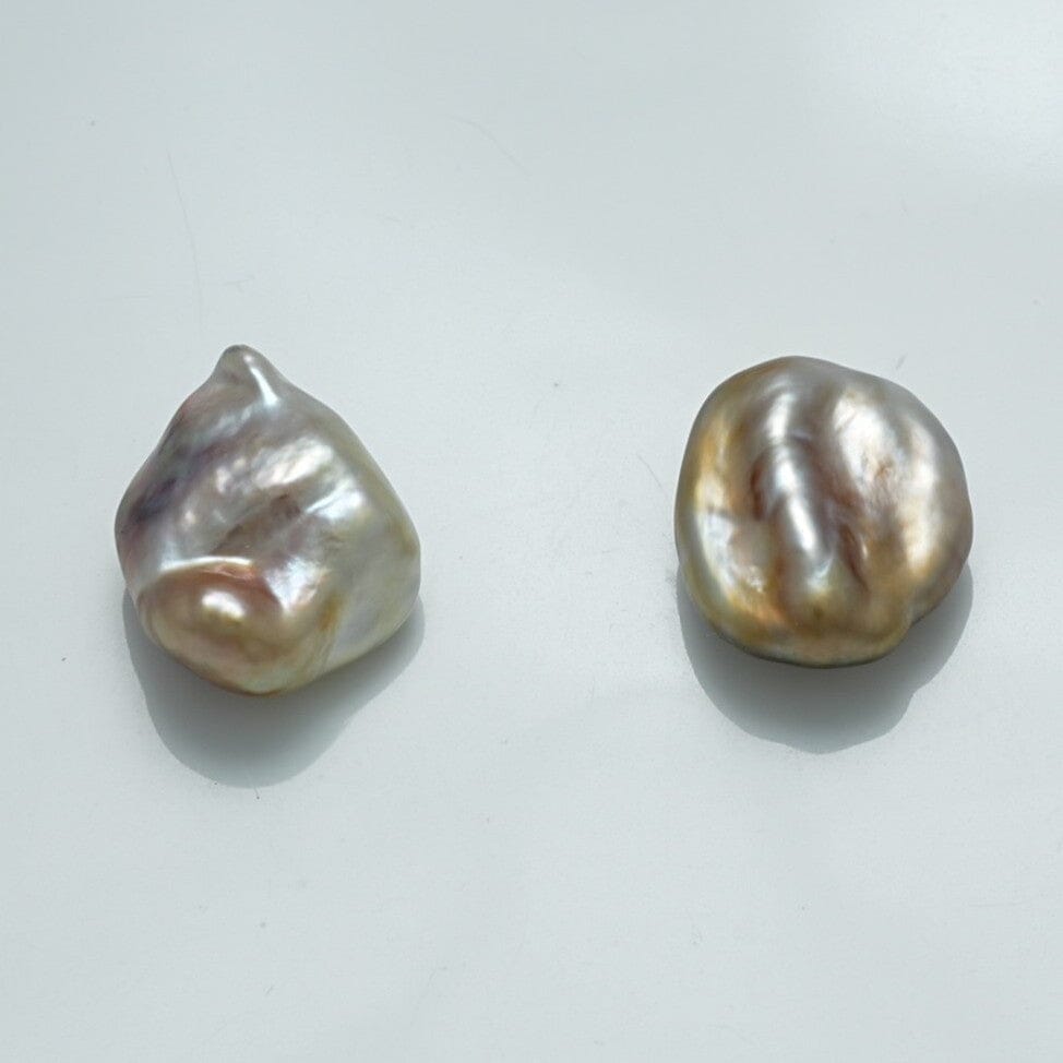 13.4 x 11.0 mm and 12.5 x 10.6 mm Fijian Keshi Pearl Pair with lustrous, irregular shapes and a soft mix of white, silver, and subtle gold hues, showcasing natural beauty.