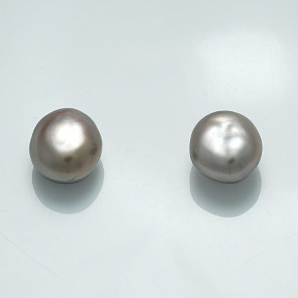 Two lustrous white pearls with irregular shapes reflecting soft light, identified as the 9.9 x 9.1 x 6.9 mm and 10.0 x 9.2 x 7.0 mm Fijian Keshi Pearl Pair.
