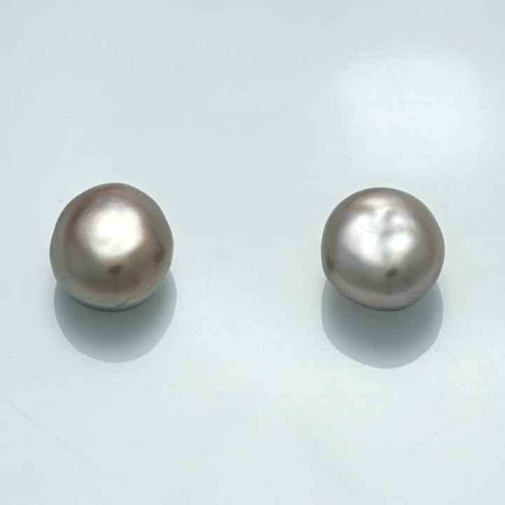 Two lustrous white pearls with irregular shapes reflecting soft light, identified as the 9.9 x 9.1 x 6.9 mm and 10.0 x 9.2 x 7.0 mm Fijian Keshi Pearl Pair.