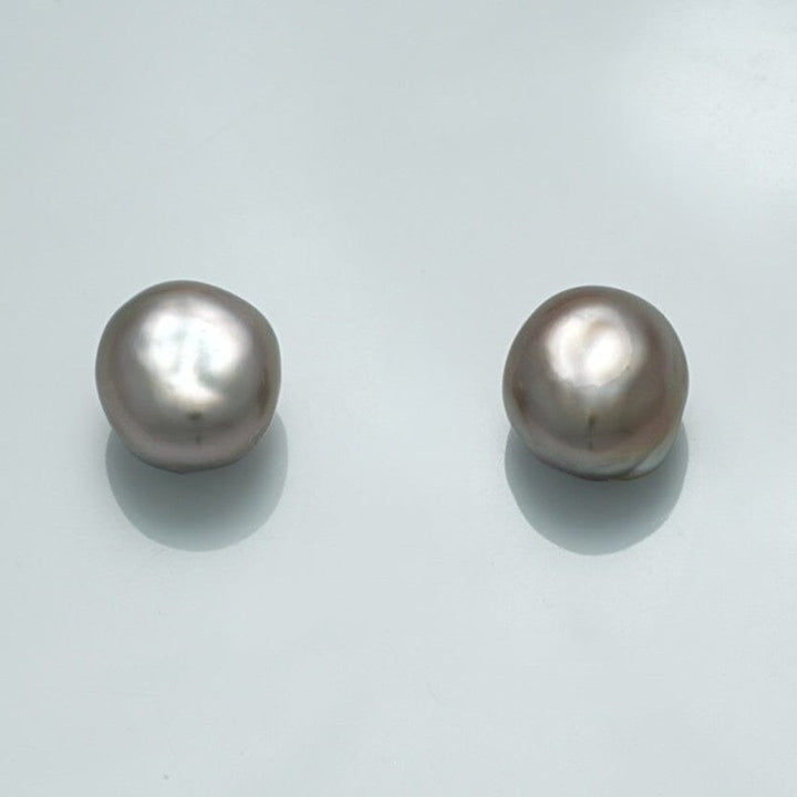Close-up of 9.9 x 9.1 x 6.9 mm and 10.0 x 9.2 x 7.0 mm Fijian Keshi Pearl Pair showcasing their irregular shapes and soft lustrous surface.