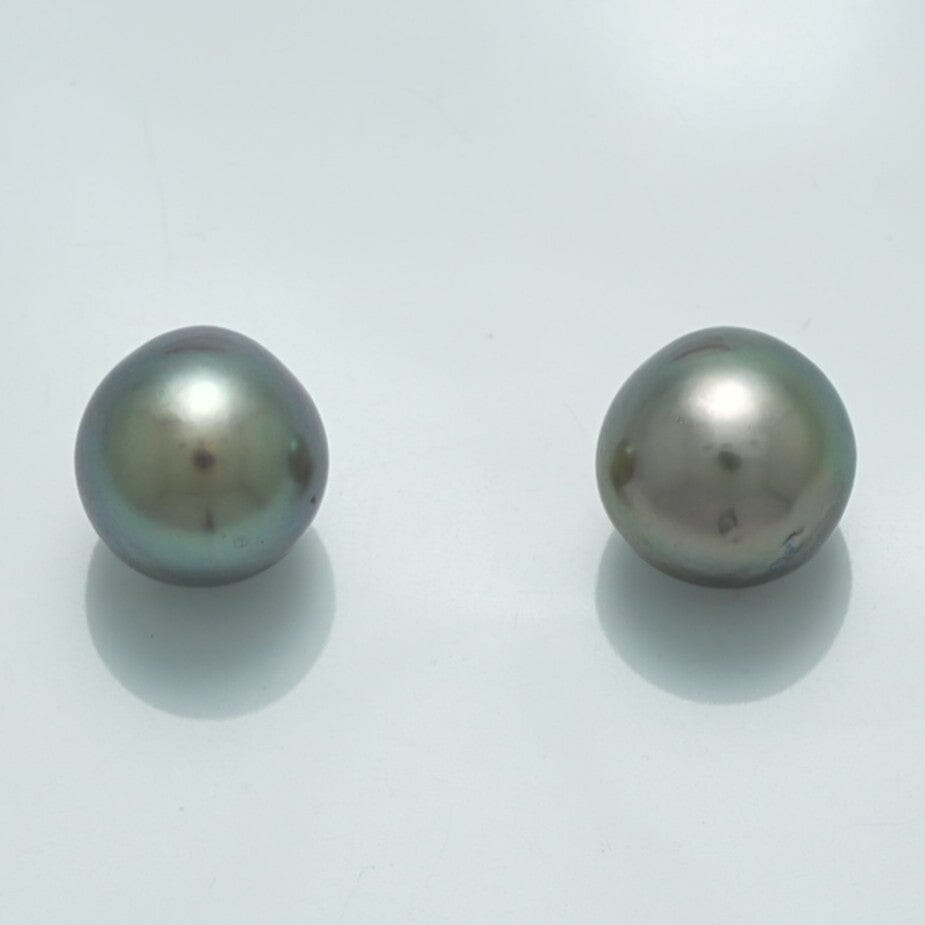 10.2 x 9.8 mm and 9.9 x 9.8 mm Fijian Drop Pearl Pair with lustrous dark green and gray tones, showcasing natural shape and subtle iridescence.