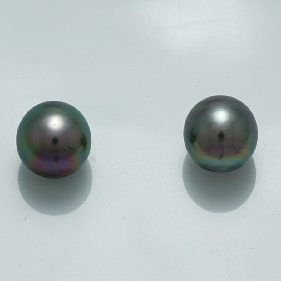10.1 x 9.5 mm and 9.9 x 9.6 mm Fijian Drop Pearl Pair showcasing lustrous dark pearls with subtle iridescent hues against a plain white background.