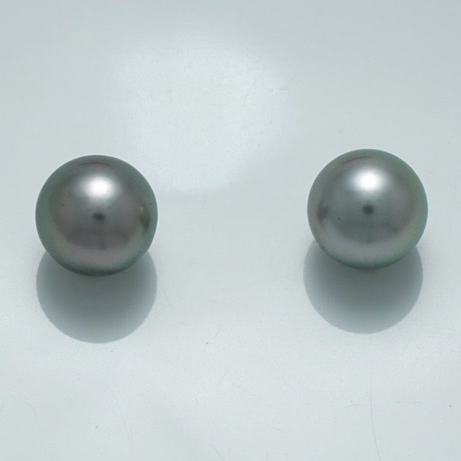 9.4 x 9.4 mm and 9.4 x 9.4 mm Fijian Pearl Pair featuring smooth, lustrous dark gray pearls with subtle iridescent sheen on a clean white background.