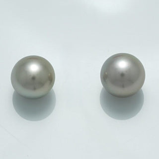Pair of lustrous round pearls with smooth surfaces in soft white tones, identified as the 10.6 x 10.5 mm and 10.5 x 10.4 mm Fijian Round Pearl Pair.