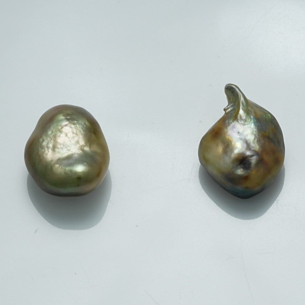 14.7 x 10.7 mm and 13.2 x 10.5 mm Fijian Keshi Pearl Pair showcasing unique baroque shapes with lustrous greenish and golden overtones, perfect for fine pearl jewelry collections.