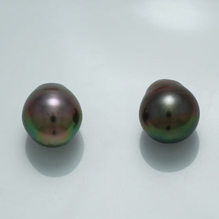 12.9 x 11.0 mm and 12.3 x 11.1 mm Fijian Drop Pearl Pair with dark iridescent hues and a smooth, lustrous surface, showcasing fine cultured pearls for elegant jewelry designs.