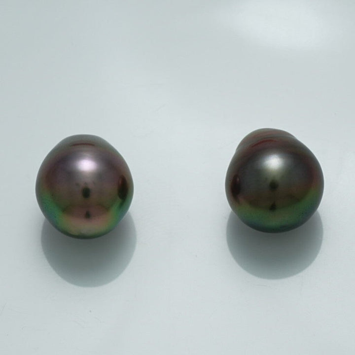 12.9 x 11.0 mm and 12.3 x 11.1 mm Fijian Drop Pearl Pair with dark iridescent hues and a smooth, lustrous surface, showcasing fine cultured pearls for elegant jewelry designs.