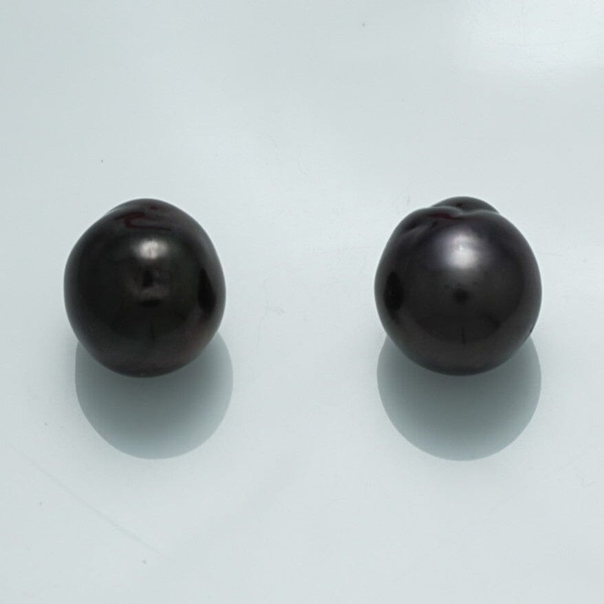 12.4 x 11.6 x 11.3 mm and 12.9 x 11.4 x 11.2 mm Fijian Baroque Pearl Pair with lustrous dark surfaces and unique organic shapes, showcasing fine cultured black pearls.