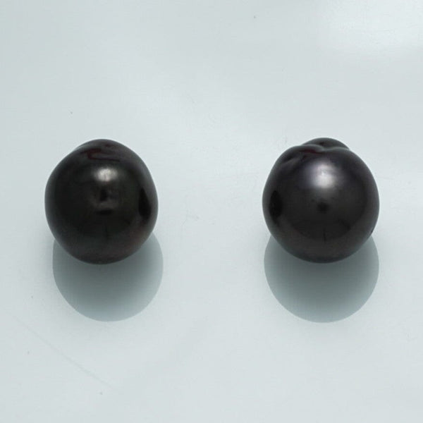 12.4 x 11.6 x 11.3 mm and 12.9 x 11.4 x 11.2 mm Fijian Baroque Pearl Pair with lustrous dark surfaces and unique organic shapes, showcasing fine cultured black pearls.