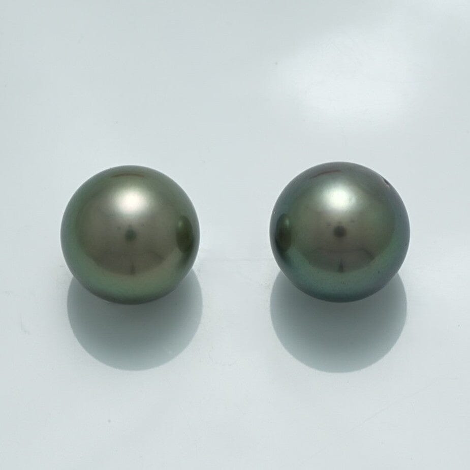13.0 x 13.0 mm and 13.0 x 13.0 mm Fijian Round Pearl Pair featuring two lustrous dark green cultured pearls with smooth surfaces against a light background.