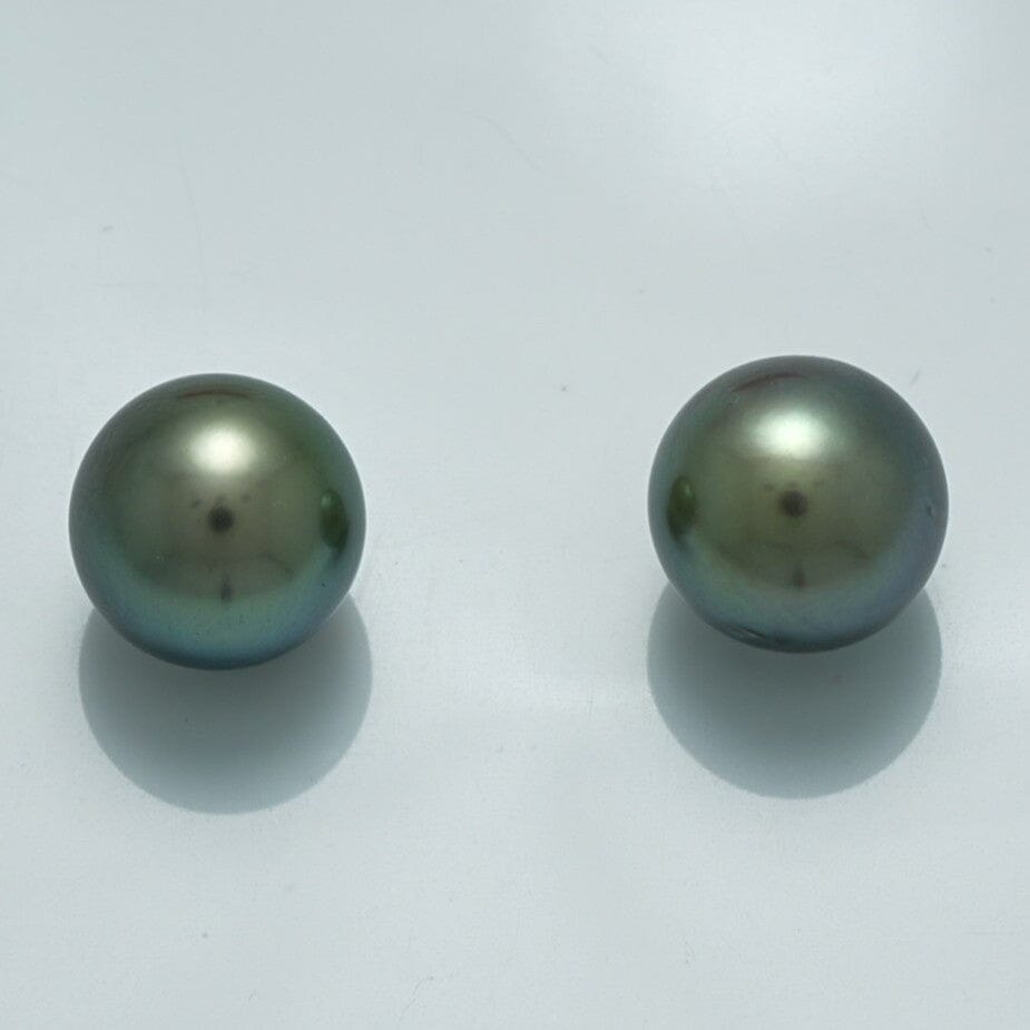 10.3 x 10.3 mm and 10.5 x 10.4 mm Fijian Pearl Pair showcasing round, lustrous dark pearls with subtle green and blue overtones on a light background.