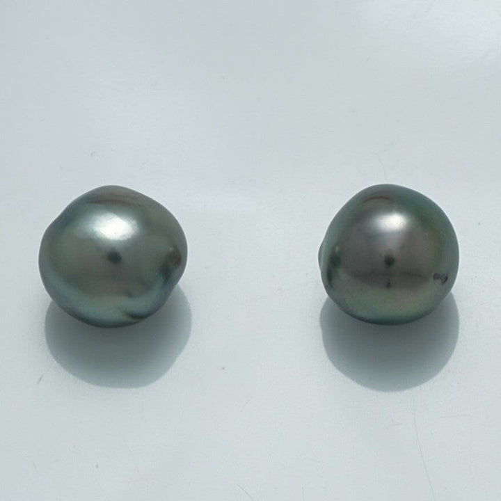 10.2 x 9.8 mm and 9.7 x 9.6 mm Fijian Semi-Baroque Pearl Pair with lustrous dark green and gray tones, showcasing natural irregular shapes and glossy surfaces.
