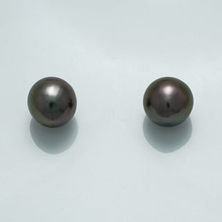 9.8 x 9.6 x 9.2 mm and 19.7 x 9.5 x 9.4 mm Fijian Drop Pearl Pair showcasing dark lustrous black pearls with subtle iridescent overtones on a light background.