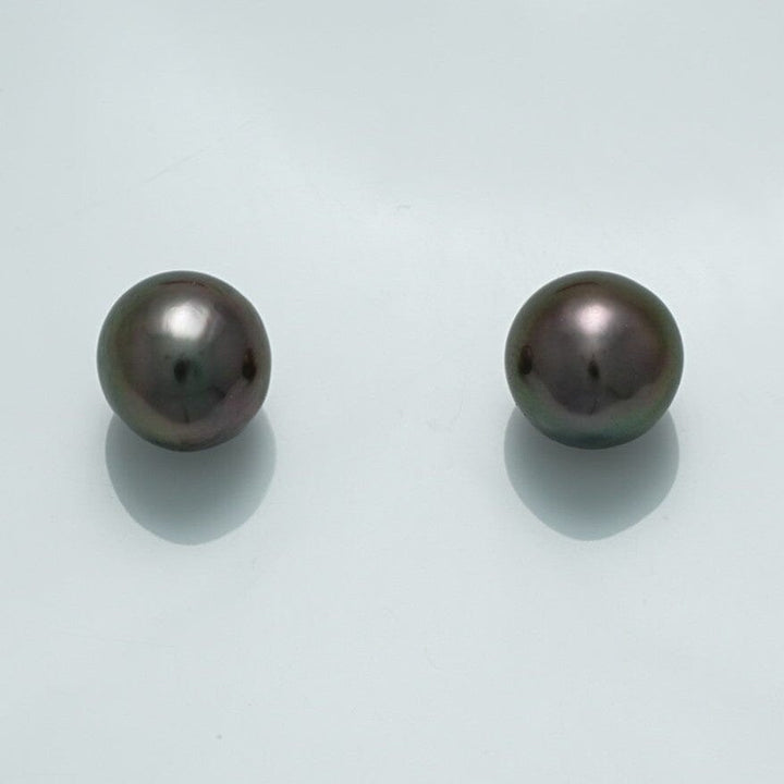 9.8 x 9.6 x 9.2 mm and 19.7 x 9.5 x 9.4 mm Fijian Drop Pearl Pair showcasing dark lustrous black pearls with subtle iridescent overtones on a light background.