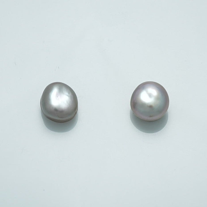 9.6 x 9.0 mm and 9.6 x 8.6 mm Fijian Keshi Button Pearl Pair with lustrous, irregular shapes showcasing natural white and soft lavender hues.