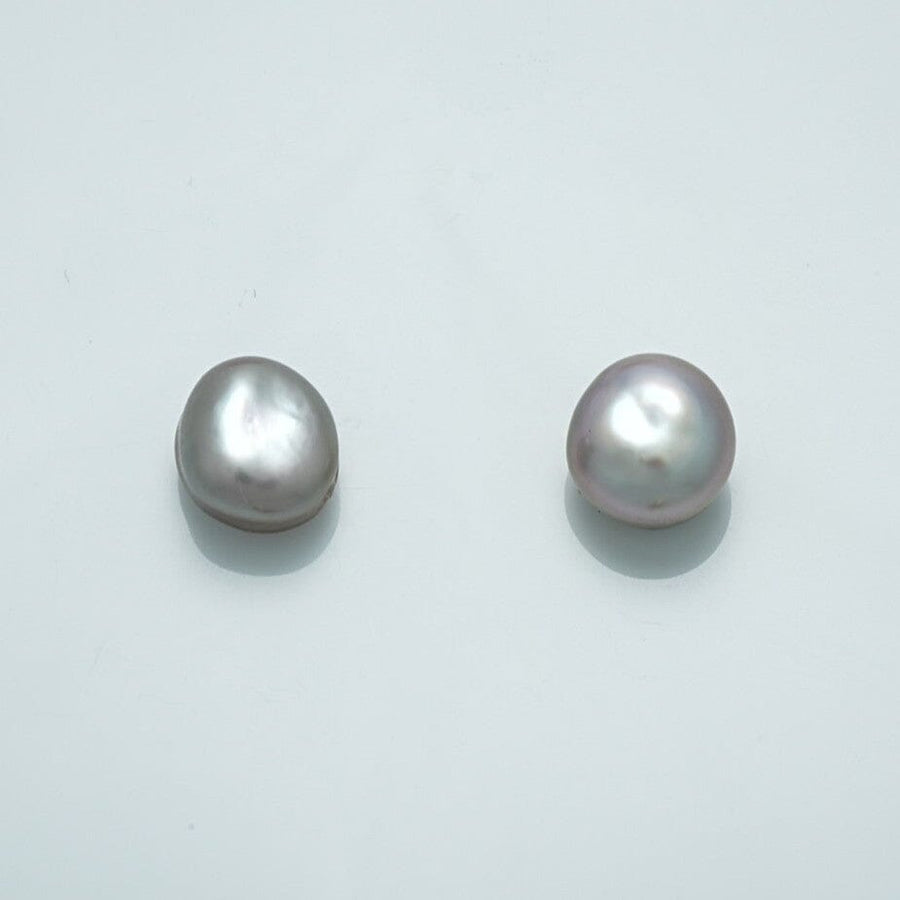 9.6 x 9.0 mm and 9.6 x 8.6 mm Fijian Keshi Button Pearl Pair with lustrous, irregular shapes showcasing natural white and soft lavender hues.