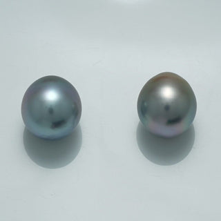 12.1 x 10.9 mm and 12.2 x 10.8 mm Fijian Drop Pearl Pair showcasing two lustrous, smooth drop-shaped pearls with subtle silver and gray hues on a plain light background.