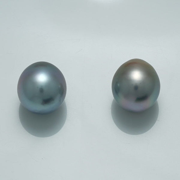 12.1 x 10.9 mm and 12.2 x 10.8 mm Fijian Drop Pearl Pair showcasing two lustrous, smooth drop-shaped pearls with subtle silver and gray hues on a plain light background.