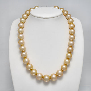 12.1-15.1 mm AAA Round Light Golden South Sea Pearl Necklace on a dark background