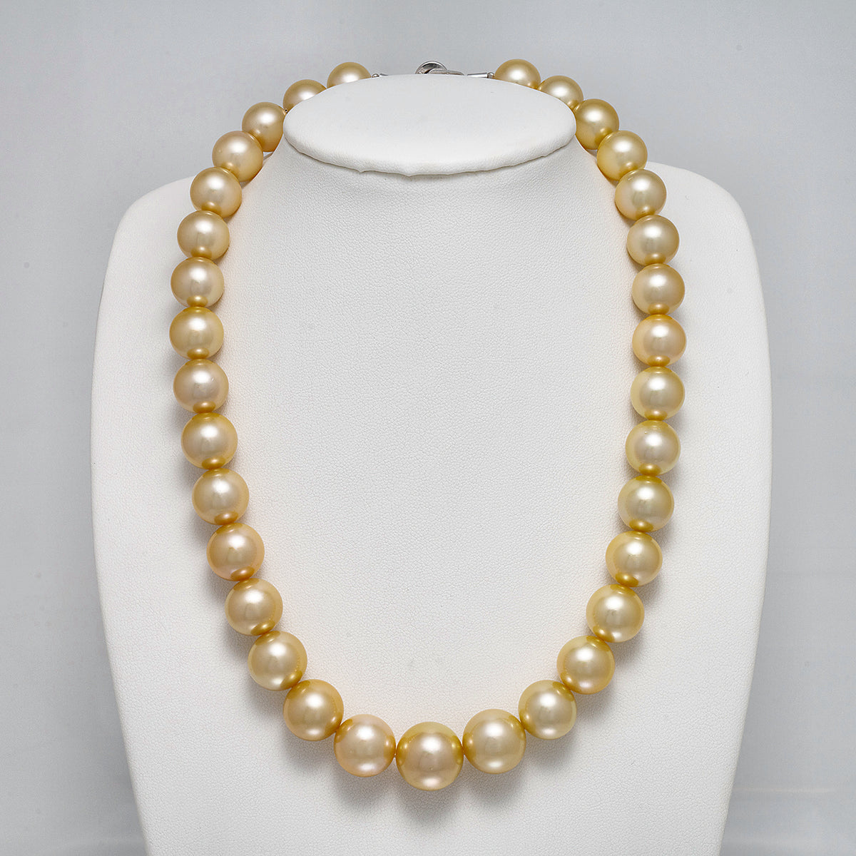 12.0-15.4 mm AAA Round Light Golden South Sea Pearl Necklace on a dark background