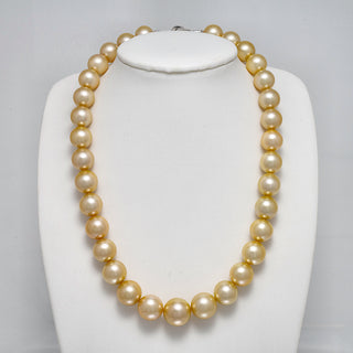 12.0-15.4 mm AAA Round Light Golden South Sea Pearl Necklace on a dark background