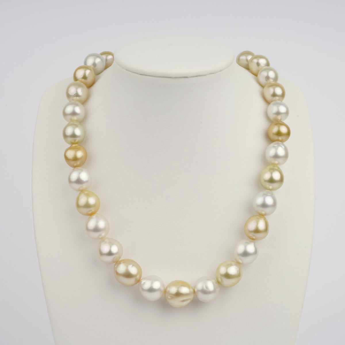 Necklace displayed on a white bust featuring 12.0–15.5 mm AAA white and golden South Sea semi-baroque pearls with lustrous irregular shapes.