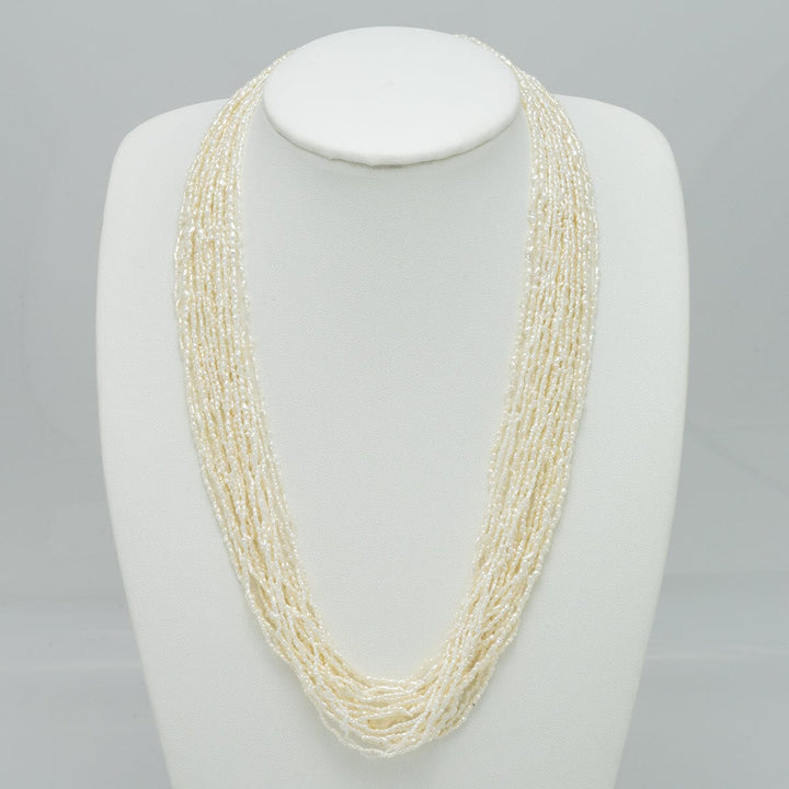 1.0-3.0 mm 20 Strand Akoya Keshi Pearl Torsade Diamond Clasp Necklace displayed on a white bust, featuring multiple strands of delicate white Keshi pearls with a sparkling diamond clasp.