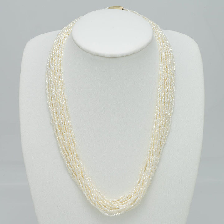 1.0-3.0 mm 20 Strand Akoya Keshi Pearl Torsade Diamond Clasp Necklace displayed on a white bust, featuring multiple strands of delicate white akoya pearls with a sparkling diamond clasp.