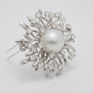 Assael Collection: 17.0 mm White South Sea Pearl and Diamond Brooch featuring a large white pearl surrounded by an intricate design of sparkling diamonds and white gold accents.