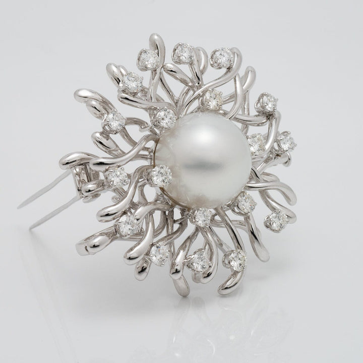 Assael Collection: 17.0 mm White South Sea Pearl and Diamond Brooch featuring a large white pearl surrounded by an intricate design of sparkling diamonds and white gold accents.