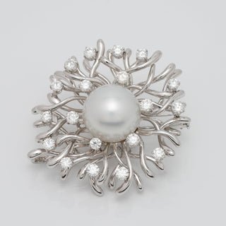 Assael Collection: 17.0 mm White South Sea Pearl and Diamond Brooch featuring a large white pearl centerpiece surrounded by a swirl of white gold branches accented with sparkling diamonds.