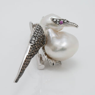 Assael Collection: 14.0 mm White South Sea Pearl, Diamond and Sapphire Brooch designed as a bird with a lustrous pearl body, diamond-studded wings, and a sapphire eye.