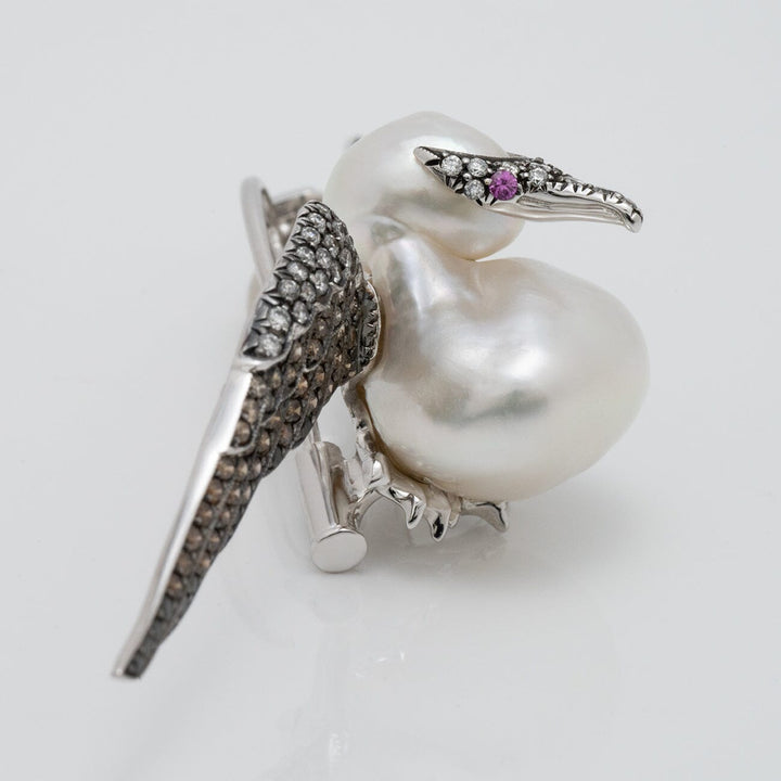 Assael Collection: 14.0 mm White South Sea Pearl, Diamond and Sapphire Brooch designed as a bird with a lustrous pearl body, diamond-studded wings, and a sapphire eye.