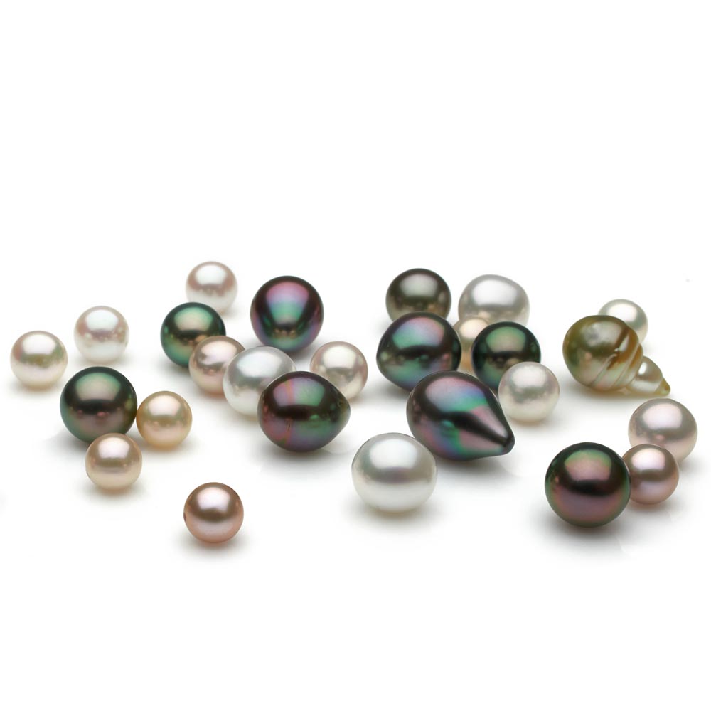 Loose white and naturally colored dark pearls of very fine quality