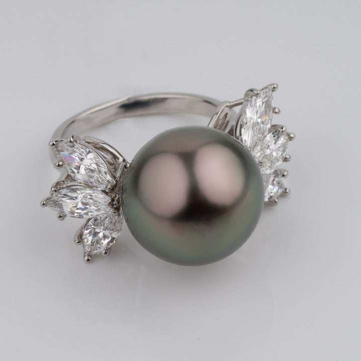 Assael Collection: 14.2 mm Tahitian Pearl and Diamond Ring featuring a large black Tahitian pearl flanked by multiple sparkling white diamonds set in a polished metal band.