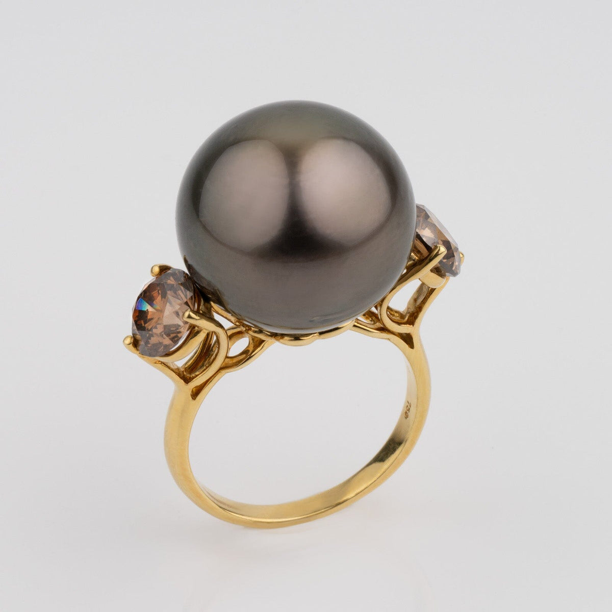 Assael Collection: 16.5 mm Tahitian Pearl and Brown Diamond Ring featuring a large dark Tahitian pearl flanked by two brown diamonds set in yellow gold, showcasing fine cultured pearls.