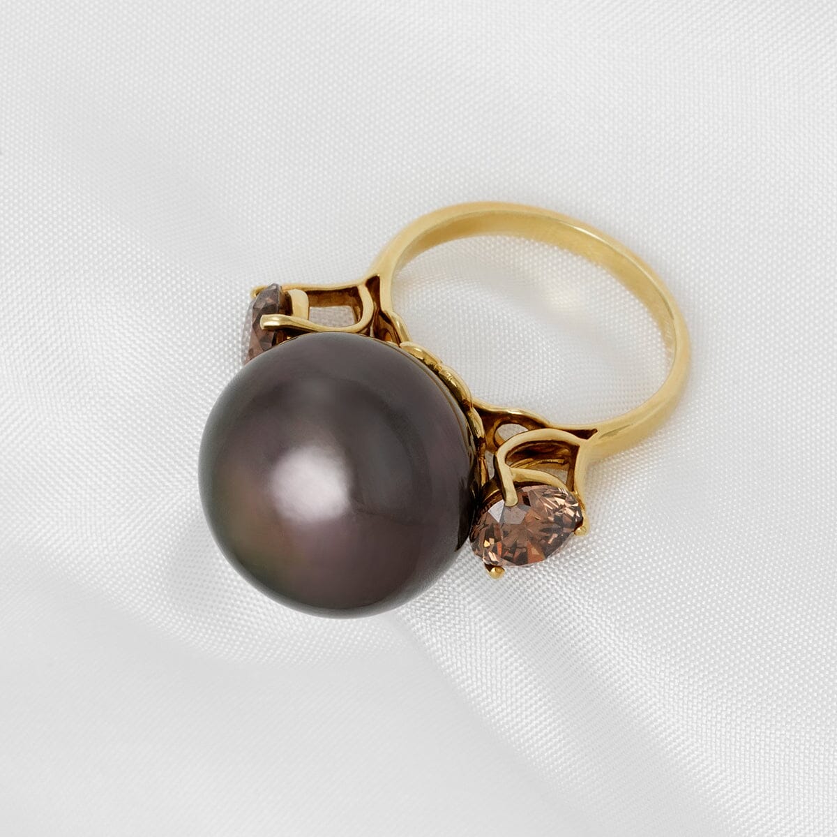 Assael Collection: 16.5 mm Tahitian Pearl and Brown Diamond Ring with a large dark Tahitian pearl centerpiece complemented by round brown diamonds set on a gold band.
