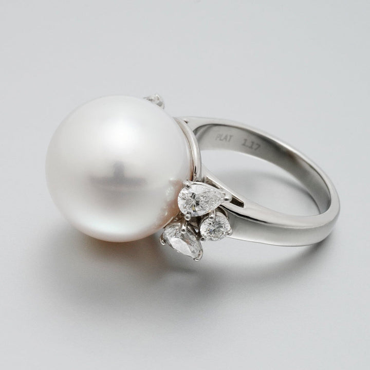 Assael Collection: 15.7 mm White South Sea Pearl and Diamond Ring featuring a large white pearl centerpiece with pear-shaped diamonds set on a polished platinum band.