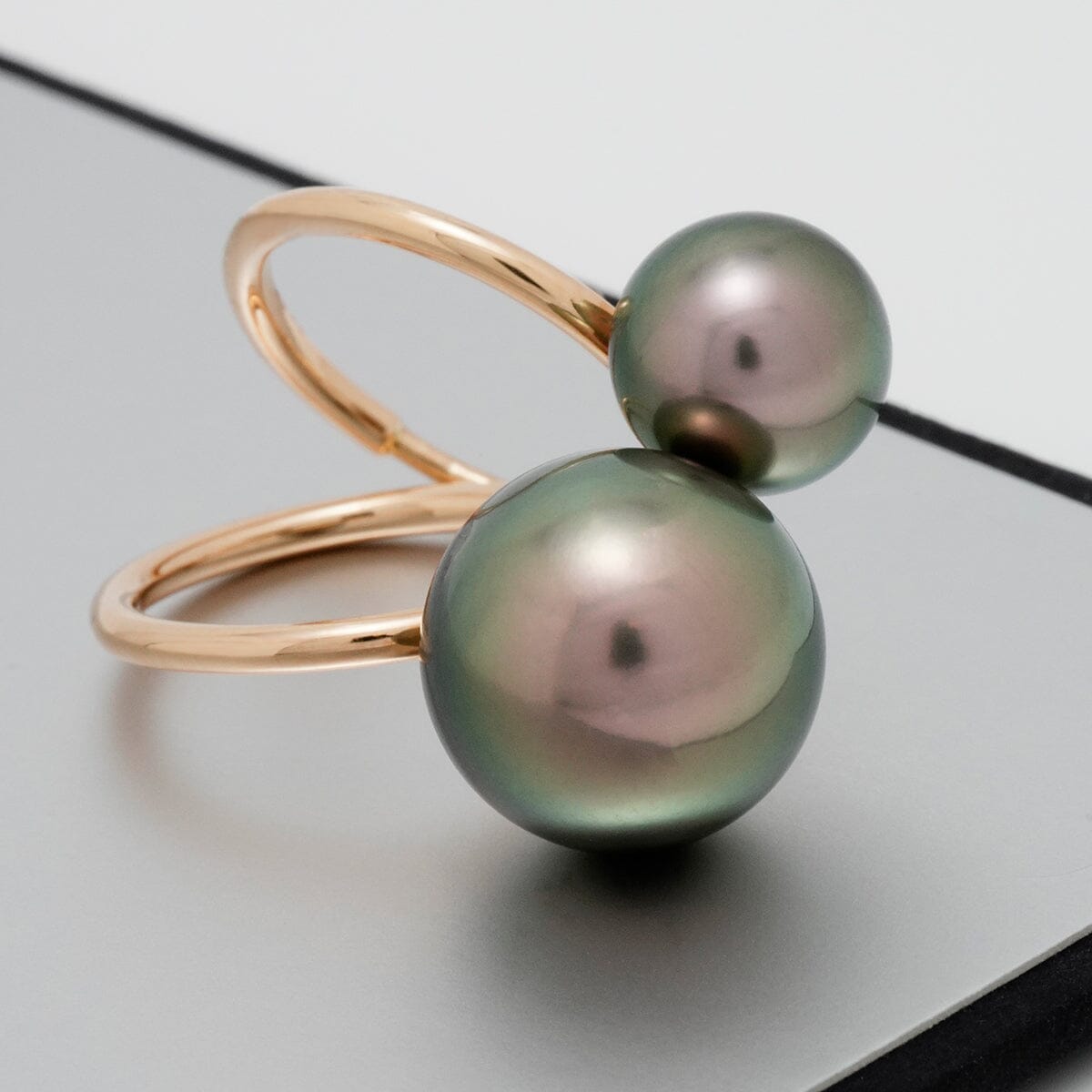 Elegant gold ring featuring two lustrous Tahitian pearls, one larger and one smaller, showcasing the Assael Collection: 10.1 and 14.2 mm Tahitian Pearl Ring design.
