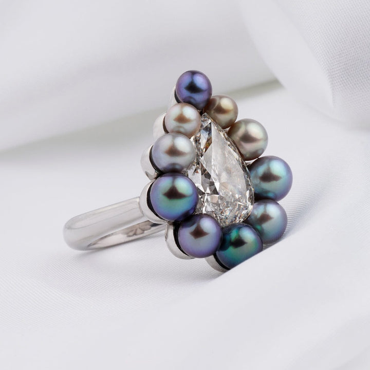Assael Collection: 10.95 Carat Natural Pearl and 5.05 Carat Natural Diamond Platinum Ring featuring a pear-shaped diamond surrounded by dark and light natural pearls in a platinum setting.