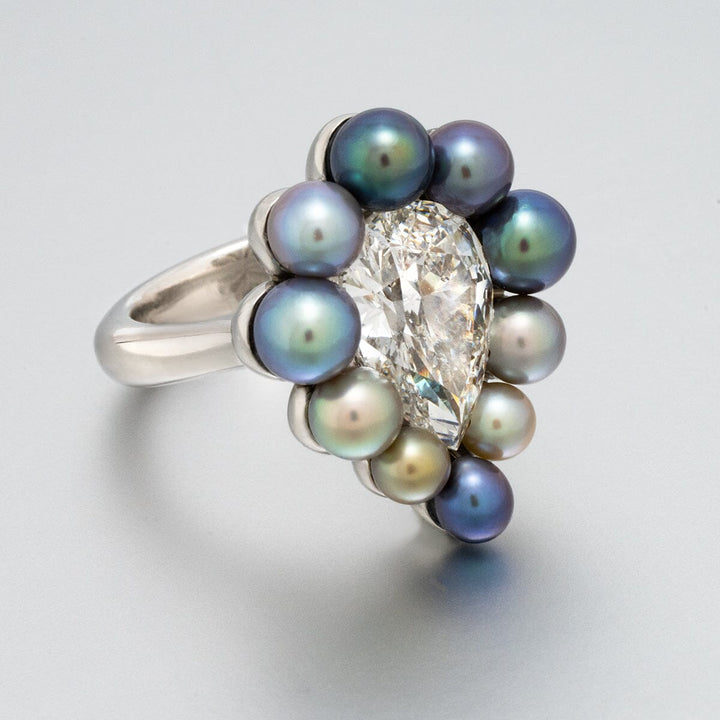 Assael Collection: 10.95 Carat Natural Pearl and 5.05 Carat Natural Diamond Platinum Ring featuring a pear-shaped diamond surrounded by a halo of multicolored natural pearls on a polished platinum band.